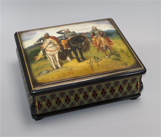 A Fedoskino Russian lacquer papier mache large box, painted by Tatiana Frolova, depicting the Three Bogatyrs, dated 2010 13 x 32 x 28cm